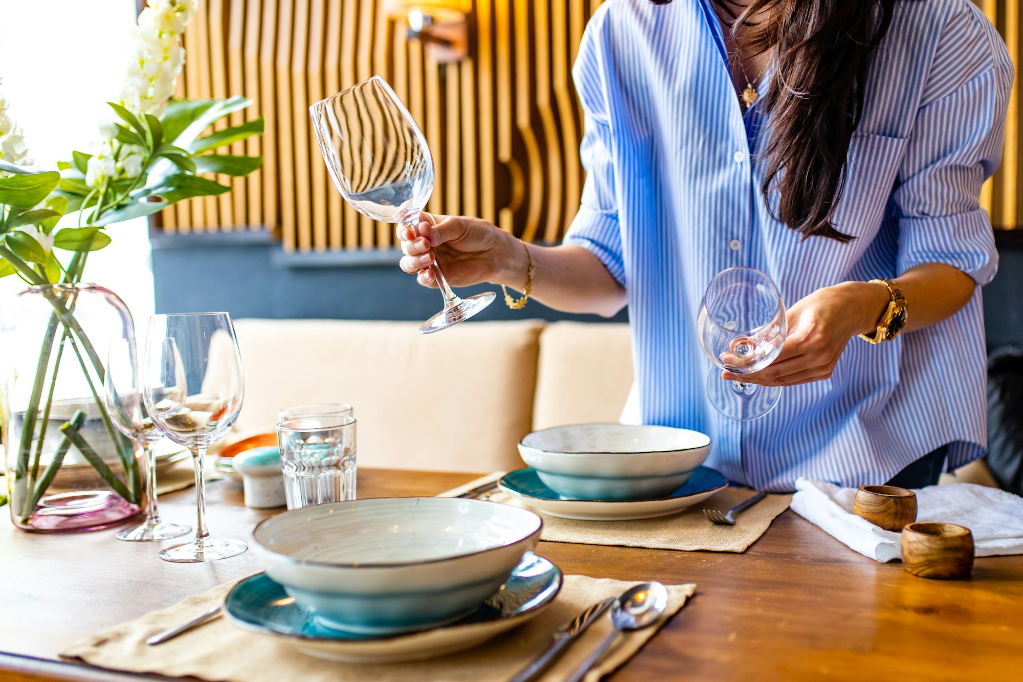 a woman reading to date setting a table in her house